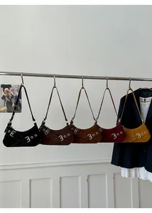 Selection of five retro suede underarm bags with buckle straps and metal eyelet details