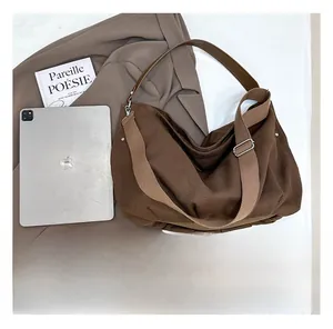 Top view of spacious brown canvas tote bag showing interior capacity and iPad comparison