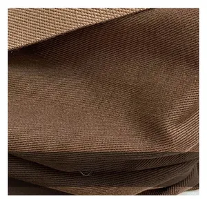 Macro close-up of thick brown canvas fabric showing the tight texture of the tote bag