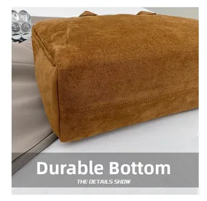 Detailed macro view of the wear-resistant caramel brown suede bottom with neat stitching