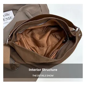 Internal structure of the brown canvas tote showing the silk lining and zip pocket