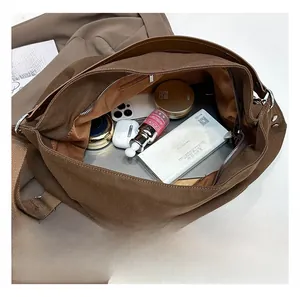 Detailed interior of the brown canvas tote bag showing large capacity for essentials