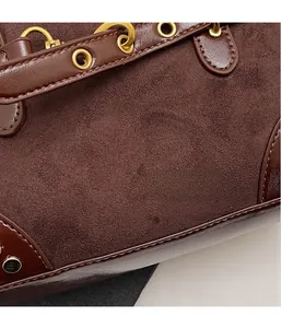Close-up of retro brown suede and smooth leather textures with gold metal buckle