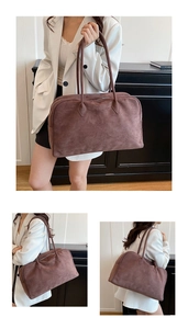 Detail shot of a large coffee brown suede tote bag in a minimalist interior setting