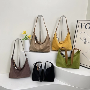 Detail of colorful suede tote bags with decorative wood beads and long shoulder straps