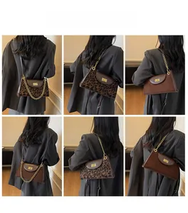 Detail showing the brown matte and leopard print shoulder bags with gold chain straps