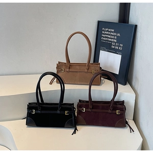 Three retro baguette bags in brown, black, and burgundy with metal buckle details