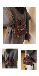 Detail of vintage brown leather bag showing stitching, gold metal hardware and textures