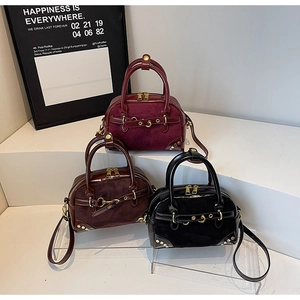 Three retro suede boston bags in burgundy, coffee and black with golden metallic hardware