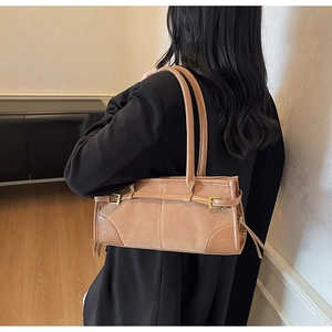 Brown suede shoulder bag with fine leather straps and vintage metallic buckle detail