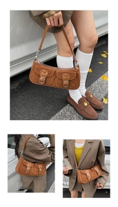 Detailansicht der braunen Vintage-Wildledertasche mit Schnallen und Schultergurt im Freien