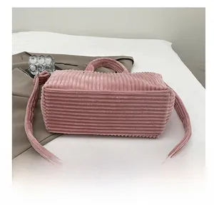 Detailed close-up of the wear-resistant bottom on pink corduroy tote shoulder bag