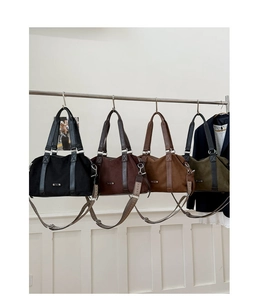 Detailed row of large corduroy tote bags in black, brown, tan, and dark green colors