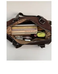Top view of spacious interior of brown Boston bag showing daily essentials and lining