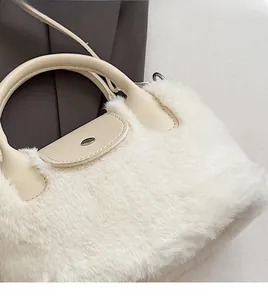 Detail of white faux fur handbag with beige leather flap and silver metal lock closure