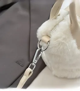 Close-up of fluffy white faux fur texture with high-quality silver metal hooks and strap