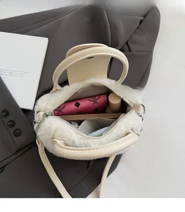 Interior view showing the spacious capacity of this plush cream faux fur handbag
