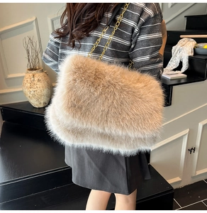 Detail of light brown faux fur tote bag featuring a premium gold metal chain strap