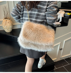 Close-up of a fluffy faux fur crossbody bag in light brown with a gold chain strap