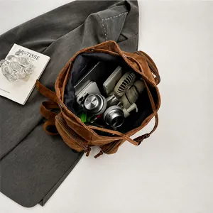Detailed interior view of a large brown canvas backpack showing spacious storage capacity