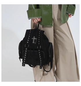 Detail of gothic black tote backpack with silver rivets and cross pendant chain