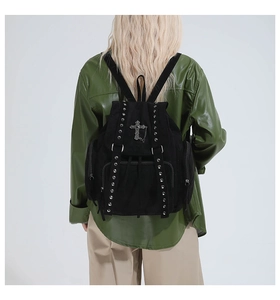 Detail of gothic black tote backpack with metallic rivets and cross pendant charm