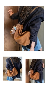 Detailed view of brown suede hobo bag with teddy bear charm and leather strap