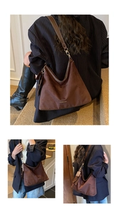 Detail of vintage matte brown suede hobo bag with gold hardware and leather shoulder strap