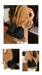 Detail view of black matte hobo tote bag featuring contrast stitching and small envelope pouch