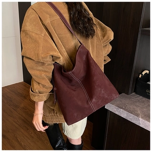 Detail der dunkelweinroten Matten Hobo-Tasche mit Kontrastnaht und breitem Schultergurt