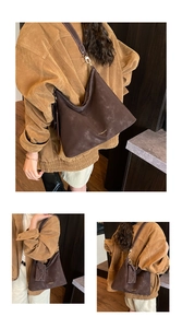 Detail of dark brown hobo bag with contrast stitching and branded gold logo lettering