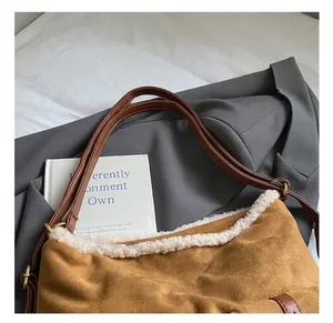 Detail showing plush trim on brown faux suede tote bag with leather shoulder straps