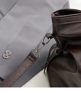 Detail of dark brown leather tote with gunmetal swivel clasp and refined stitching
