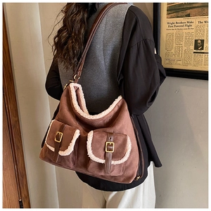 Detail view of vintage brown suede tote bag with white faux fur trim and dual front pockets