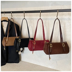 Detail of vintage oil-waxed leather baguette bags in four colors with fringe tassels