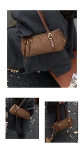 Macro shot of retro dark brown suede baguette bag with vintage gold metal buckles