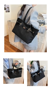 Vue détaillée d'un grand sac cabas noir avec lanières à boucles et fermoir rotatif en métal