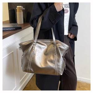 Detail of silver tote bag with star rivets and adjustable side drawstrings