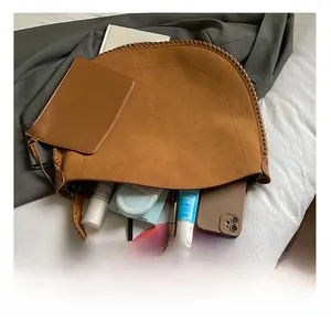 Large brown suede tote bag showing spacious interior with tablet and cosmetics