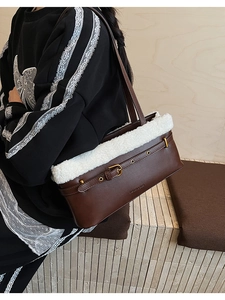 Detail of dark brown PU shoulder bag featuring faux fur trim and golden buckle hardware