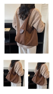 Detail of a large brown suede tote bag featuring a round coin purse and a wide shoulder strap