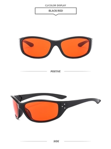 Detail view of retro sports sunglasses with black frames and orange cat-eye lenses