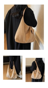 Detail view of khaki suede shoulder bag with side flap pocket and minimalist design