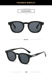 Detail view showing black oval frames and silver metal trim on the sunglasses temples
