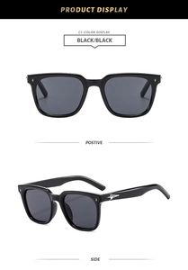 Detail of square black sunglasses showing silver star accents and side frame texture