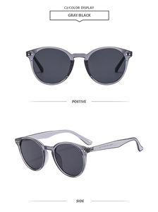 Detail view of round vintage sunglasses with gray lenses and translucent frames