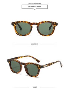 Detail view of leopard print sunglasses with green lenses and gold temple accents