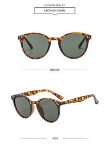 Detail of vintage round leopard sunglasses with green lenses and wavy temple design