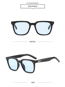 Detail of black square sunglasses featuring light blue lenses and silver star hardware