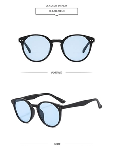 Detail view of vintage round sunglasses in black frame with light blue tinted lenses